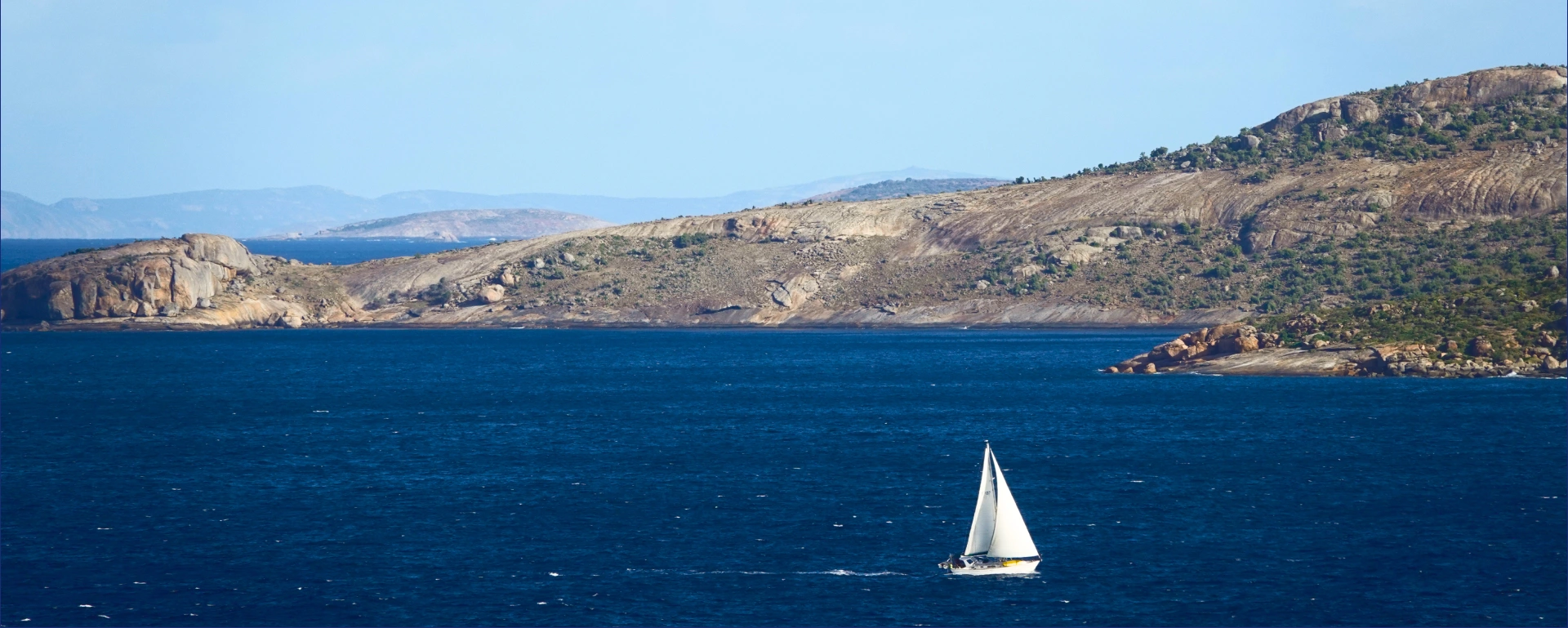 Sailing boat on blue water